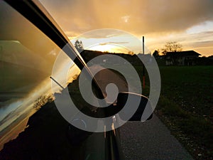 Silhouettes of a car while the sunset