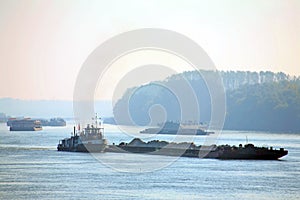 Silhouettes of cargo ships at the Danube
