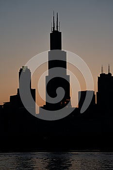 Silhouettes of Chicago Highrises over the sunset sky photo