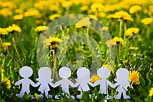 Silhouettes of children holding hands cut out of cardboard International children`s day. Copy space
