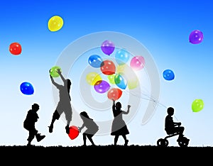 Silhouettes of Children Playing Balloons