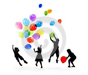 Silhouettes of Children Playing Balloons Together