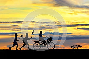 Silhouettes of children running around funny in the morning.