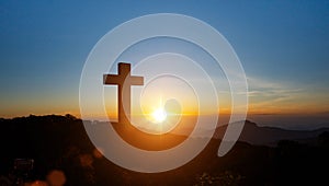 Silhouettes of Christian cross symbol on top mountain at sunrise sky background. Concept of Crucifixion Of Jesus Christ
