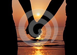 Silhouettes couples holding hands