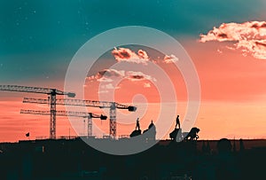 Silhouettes of cranes, statues and buildings Madrid, Spain