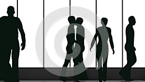 Silhouettes of a crowd of backlighted people walking in bright spacious lobby