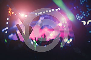 Silhouettes of crowd people in concert bright stage lights. Pink