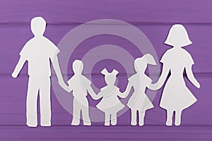 The silhouettes cut out of paper of man and woman with two girls and boy