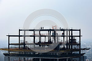 Silhouettes of engineers and construction team working at the site