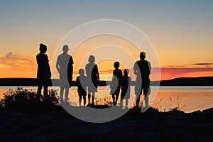 Silhouettes of a family on a trip, bonding under sunset