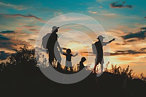 Silhouettes of a family on a trip, bonding under sunset