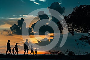 Silhouettes of a family on a trip, bonding under sunset