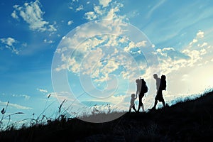 Silhouettes of a family on a trip, bonding under sunset