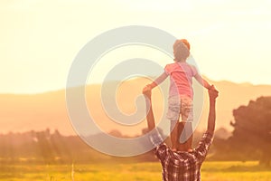 Silhouettes of father and daughter playing together