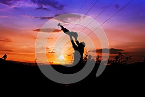 Silhouettes of father and son sunset background