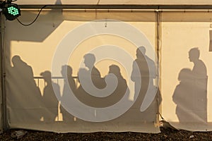 Silhouettes at a festival waiting entry