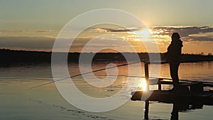 Silhouettes of fishermen at sunset of the sun.