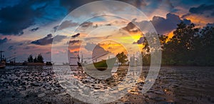 Silhouettes fishing boat and tree at sunset time, Phuket, Thailand