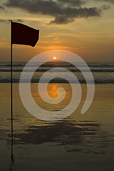 Silhouettes of a Flag on Kuta Beach at Sunset, Double Six Beach, popular surfing destination