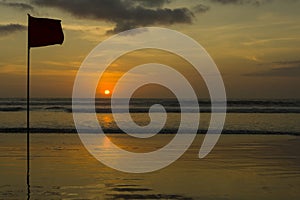 Silhouettes of a Flag on Kuta Beach at Sunset, Double Six Beach, popular surfing destination