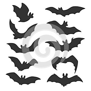 Silhouettes of flying bats. Horrific Halloween black bats. Flying foxes