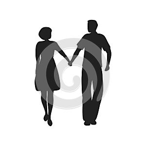 Silhouettes of a guy and a girl. A young couple is walking holding hands