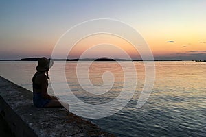 silhouettes of happy people on the beach by the sea at beautiful sunset