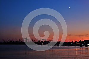 silhouettes of harbor cranes in the evening in Mangalia city - Romania