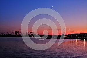 silhouettes of harbor cranes in the evening in Mangalia city - Romania