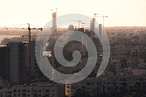 Silhouettes of high-rise buildings under construction in evening. Limassol, Cyprus