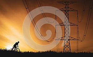 Silhouettes of high voltage poles and power lines