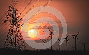 Silhouettes of high voltage poles and power lines