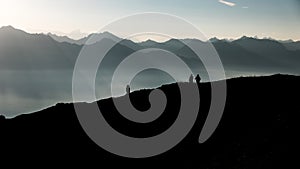 Silhouettes of hikers against mountains