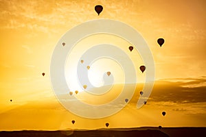 Silhouettes of hot air balloons at sunset sky. Goreme National Park in Cappadocia, Turkey