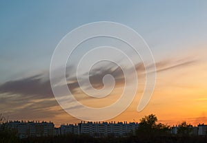 Silhouettes of houses at dusk against a beautiful evening sky at sunset