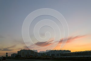 Silhouettes of houses at dusk against a beautiful evening sky at sunset