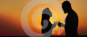 Silhouettes of man and woman at sunset dramatic sky background, couple toasting wine glasses in romantic date setting, looking eac