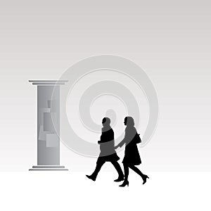 Silhouettes of man and woman walking on a street
