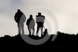 Silhouettes of men on the Etna