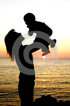 Silhouettes of mother and son partly isolated over