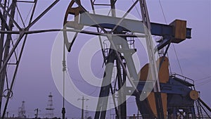 Silhouettes of oil wells pumping at sunset