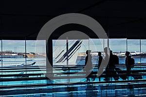 Silhouettes of people in the airport building