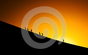 Silhouettes of people climbing photo