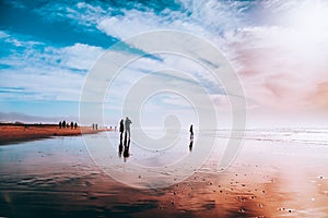 Silhouettes of people enjoying on the beach