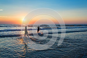 Silhouettes of people enjoying the sunset on the atlantic ocean