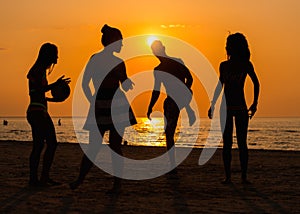 Silhouettes of a people having fun on a beach