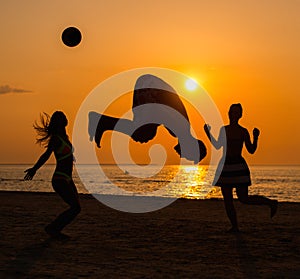 Silhouettes of a people having fun on a beach