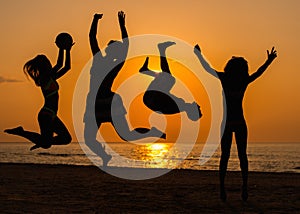 Silhouettes of a people having fun on a beach