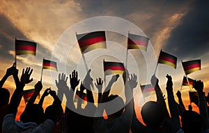 Silhouettes of People Holding the Flag of Germany